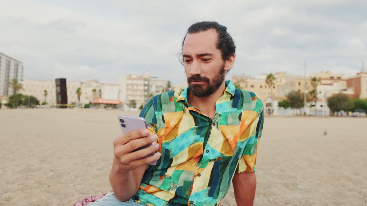 Man using phone on beach