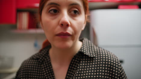 italian woman eats an almond in the kitchen