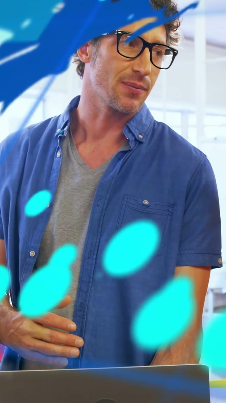 Vertical video: Man gesturing over laptop, causing blue graphic with numeric HUD, explaining tech