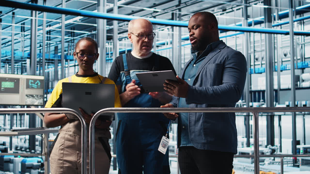 Engineers talk with manager overseeing smart factory, showing collected metrics