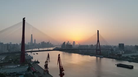 drone aerial view of sunset and the landmark bridge in shanghai china