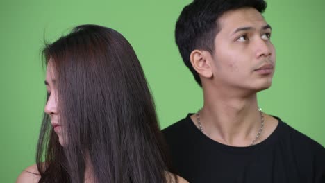 young asian couple thinking together differently