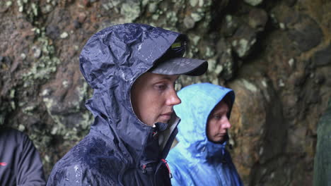 hikers in a cave, rainy weather