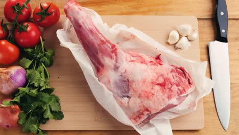 raw lamb leg with vegetables