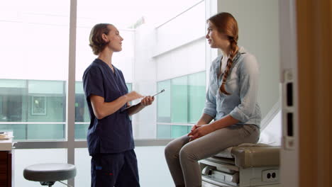 Doctor-Meets-With-Teenage-Patient-In-Exam-Room-Shot-On-R3D