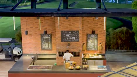 chef preparing pizza at outdoor stall