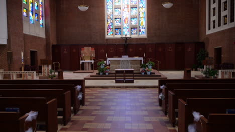 approaching altar in catholic church prepared for wedding ceremony