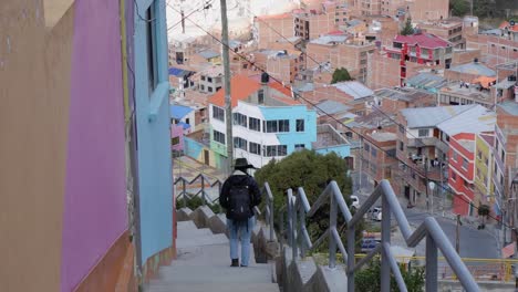 woman explores colorful hillside neighborhood in la paz, bolivia