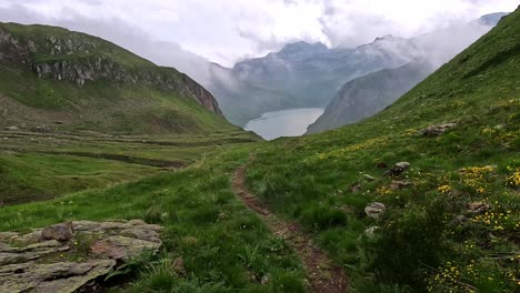 Approaching-lago-vannino,-view-over-mountain-meadows-and-a-vast-valley-in-the-Alps-of-Italy