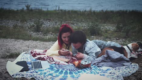 4k family having picnic next to the lake