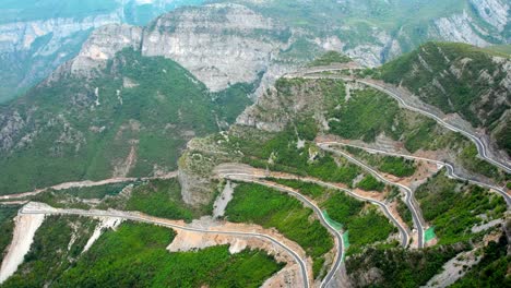 aerial of mountain road full of hairpin bends in albania border montenegro