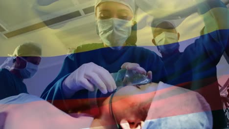 Animation-of-flag-of-colombia-flag-waving-over-surgeons-in-operating-theatre