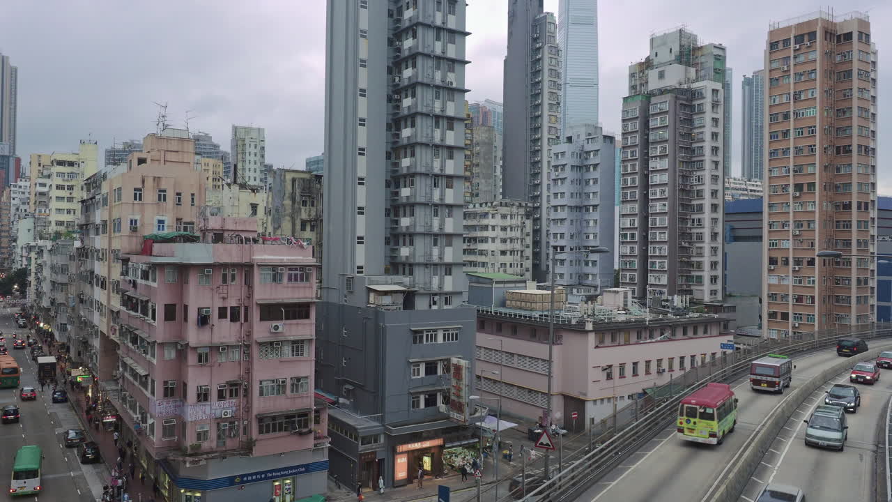 Aerial over the apartments, offices and traffic near Jordan, Kowloon, Hong Kong