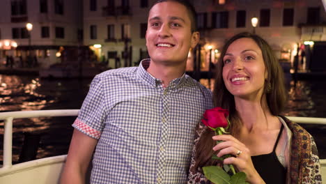 couple on a venetian canal boat at night