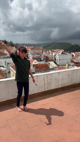 girl playing percussion on a rooftop