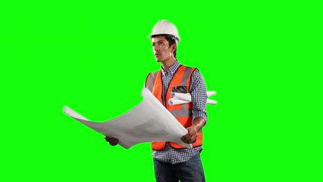 Side-view-of-site-worker-looking-at-a-site-map-with-green-screen