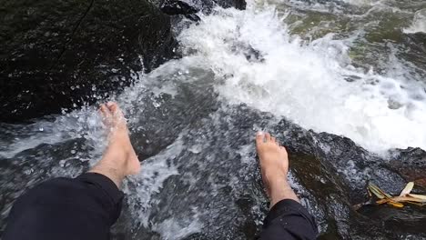 men's feet enjoying the fresh river water