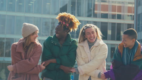 portrait of female protestors linking arms on demonstration march