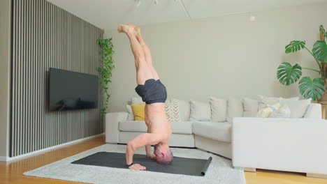 Man-Exercising-And-Doing-Headstand-In-The-Family-Room