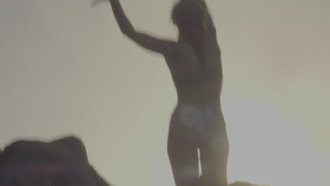 silhouette of a woman jumping at sunset