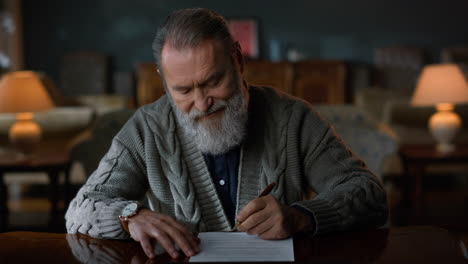 greyhaired gentleman signing contract indoors