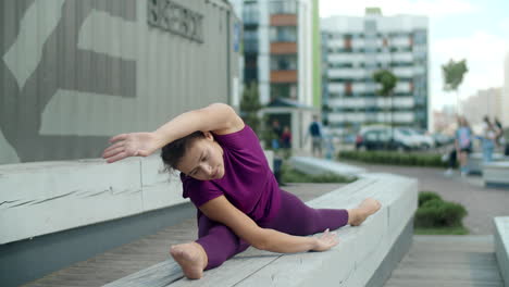teenage girl practicing yoga stretches outdoors
