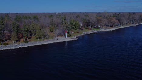 Aerial-of-a-waterfront-with-a-tiny-lighthouse