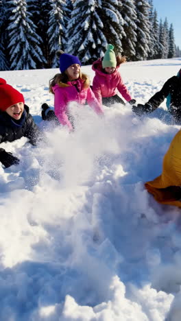 group of happy children playing in the snow on a sunny winter day