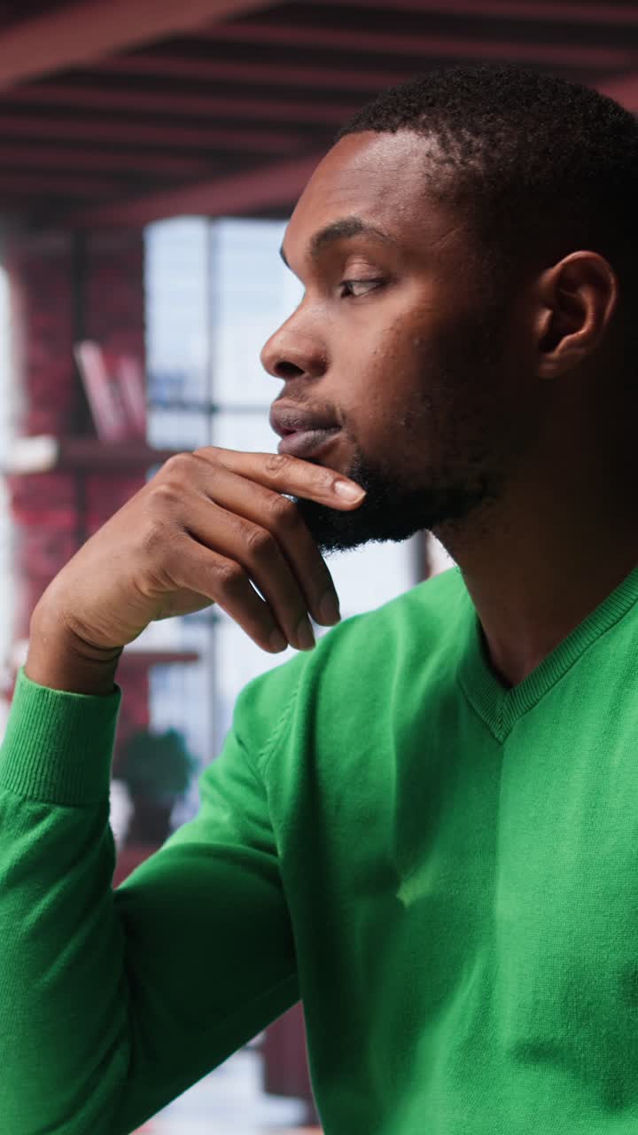 Vertical Video African american guy thinking about new ideas to increase clients numbers