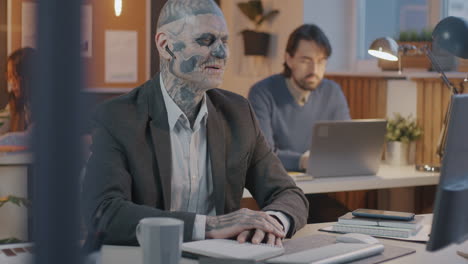 businessman with skull face tattoo in office