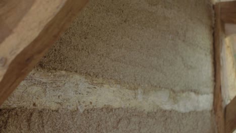 close-up side pan revealing a hempcrete wall in timber frame during construction