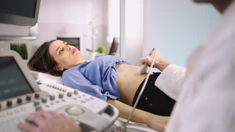 a doctor performs an ultrasound examination on a female patient