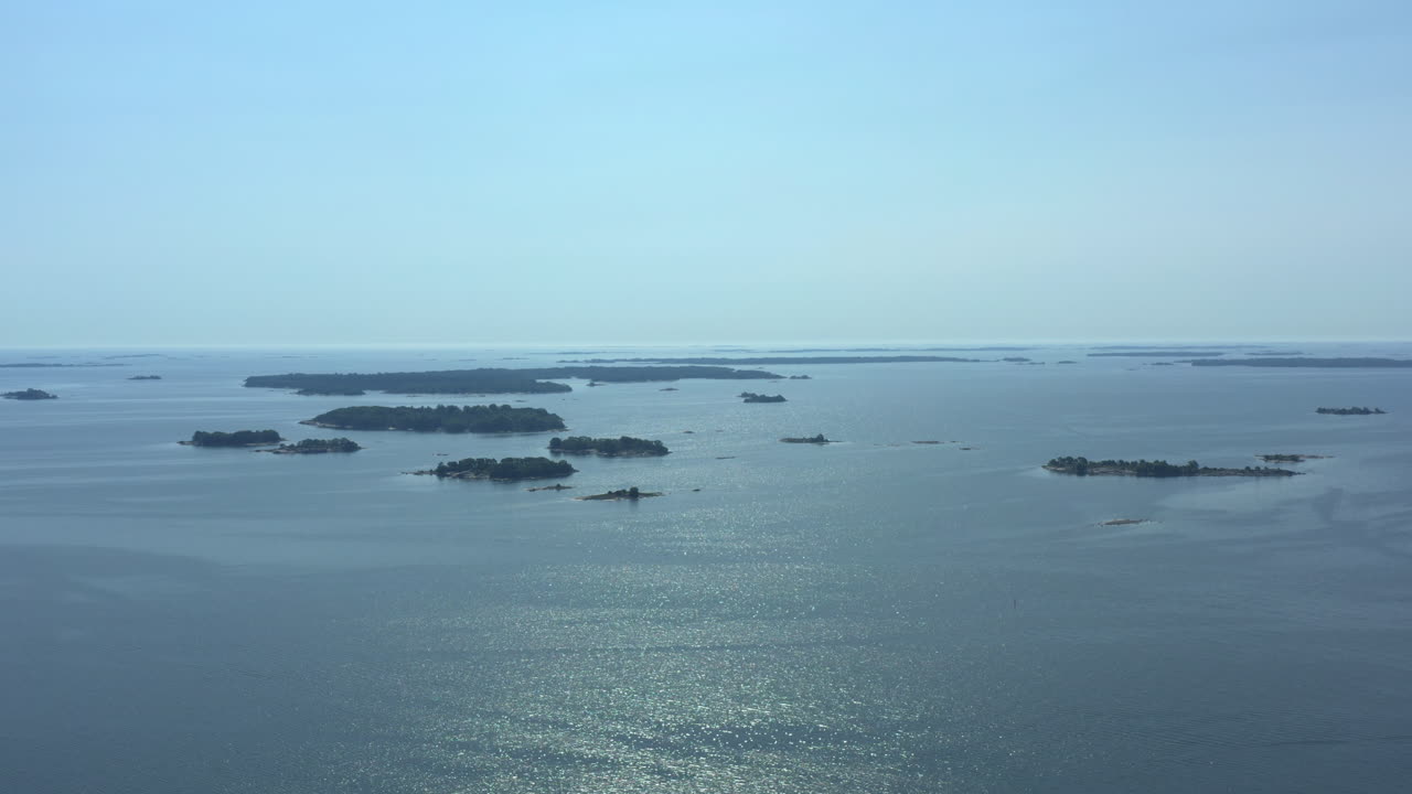 Aerial orbit wide shot over Stockholm archipelago on a beautiful sunny day overlooking the islands, travel concept