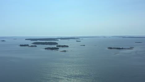 aerial orbit wide shot over stockholm archipelago on a beautiful sunny day overlooking the islands, travel concept