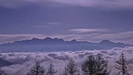 time lapse of billowing and rolling clouds or fog in the valley below the mountain peaks