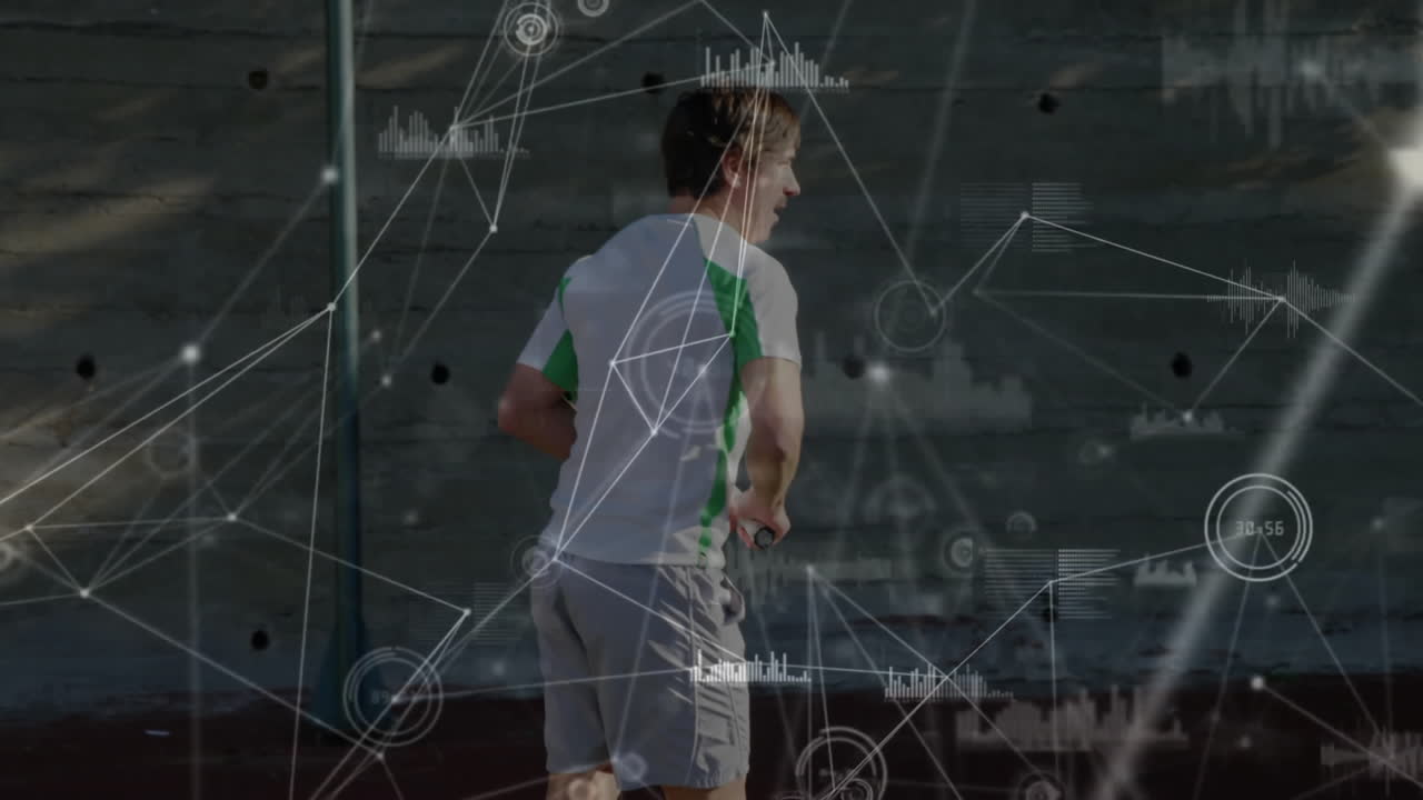 Male runner holding fitness sensor running outdoors, displaying digital network charts and graphs