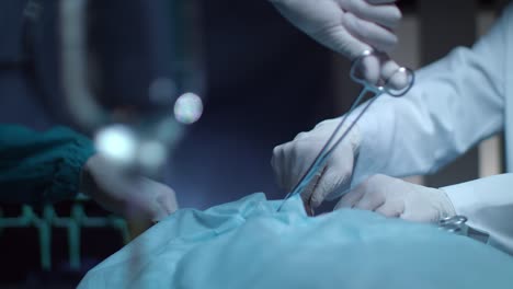 Surgery-operation-hands-in-operating-room.-Gloved-hand-hold-surgical-tools