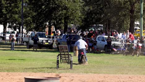 unicyclist performs a basketball shot in park