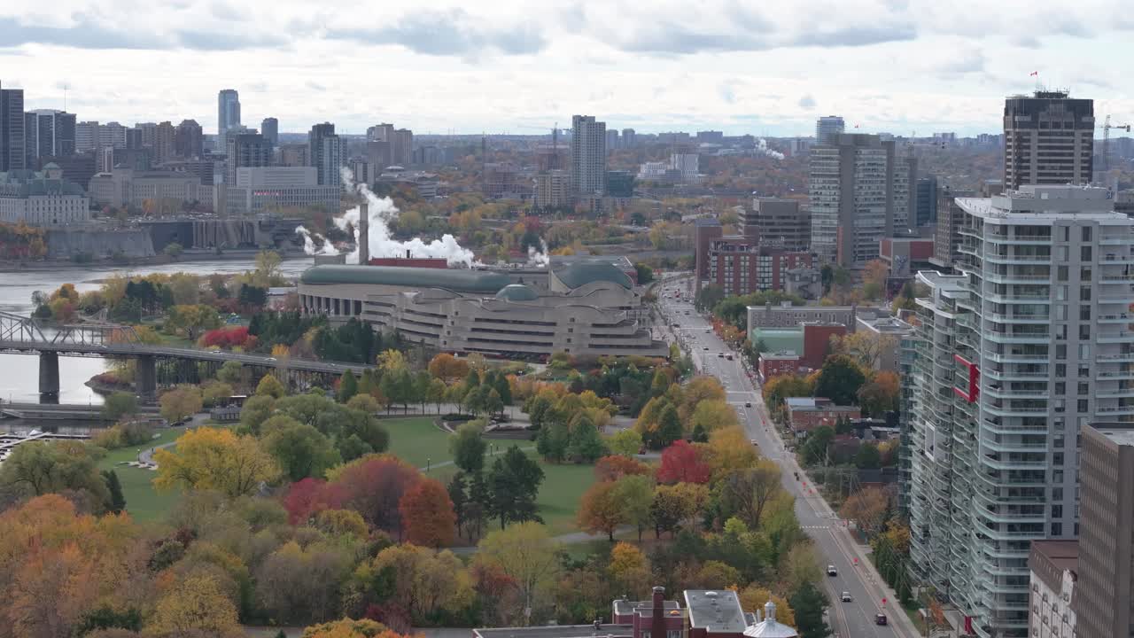 Scenic aerial drone footage of the Ottawa and Gatineau skylines, featuring the Alexandra Bridge over the Ottawa River, the National Gallery, and vibrant autumn foliage
