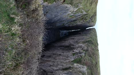 Tilt-up-shot-from-hiking-boots-on-a-cliff-revealing-Huntsman's-Leap