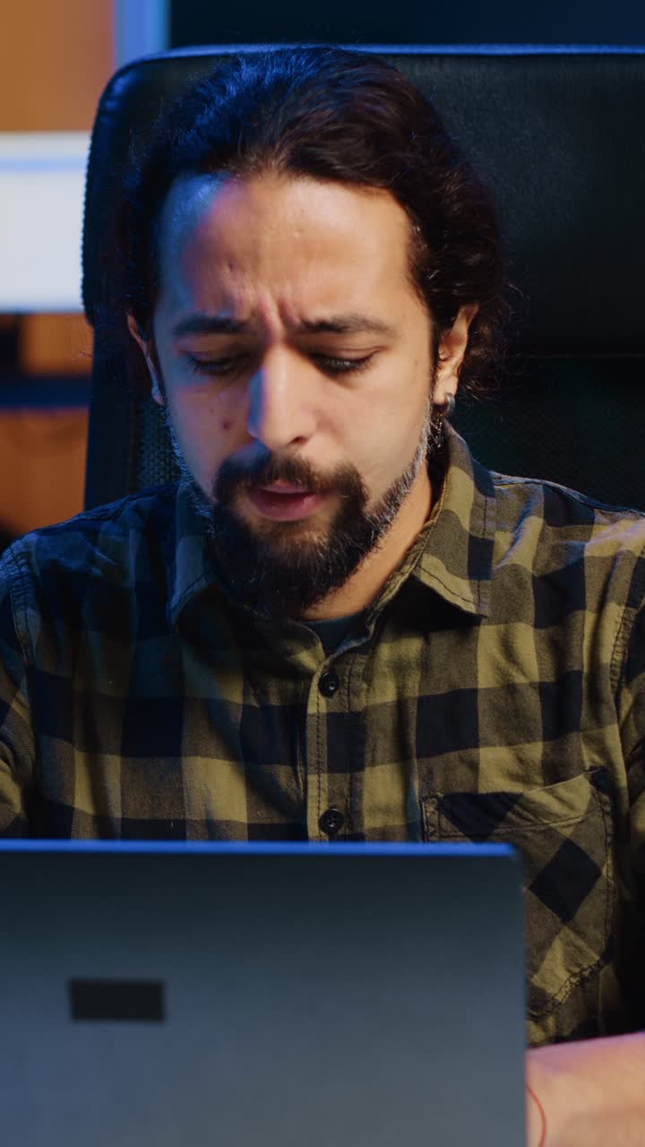 Vertical video Entrepreneur starting his day working from home, opening laptop