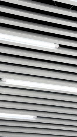 lamps of day light switched on the ceiling. long led illumination equipment black and white video. low angle view. vertical video