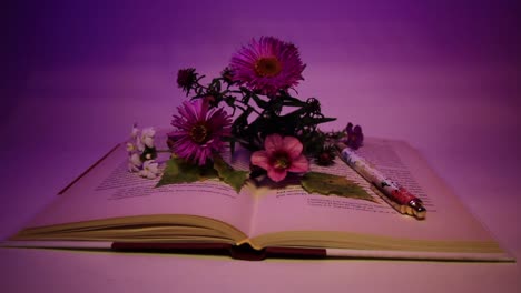 close up of flowers and pen on the book