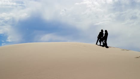 couple pointing at a distance in desert 4k