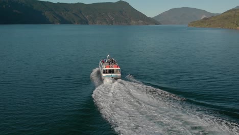 mail boat tour cruising in marlborough sounds, new zealand - aerial drone