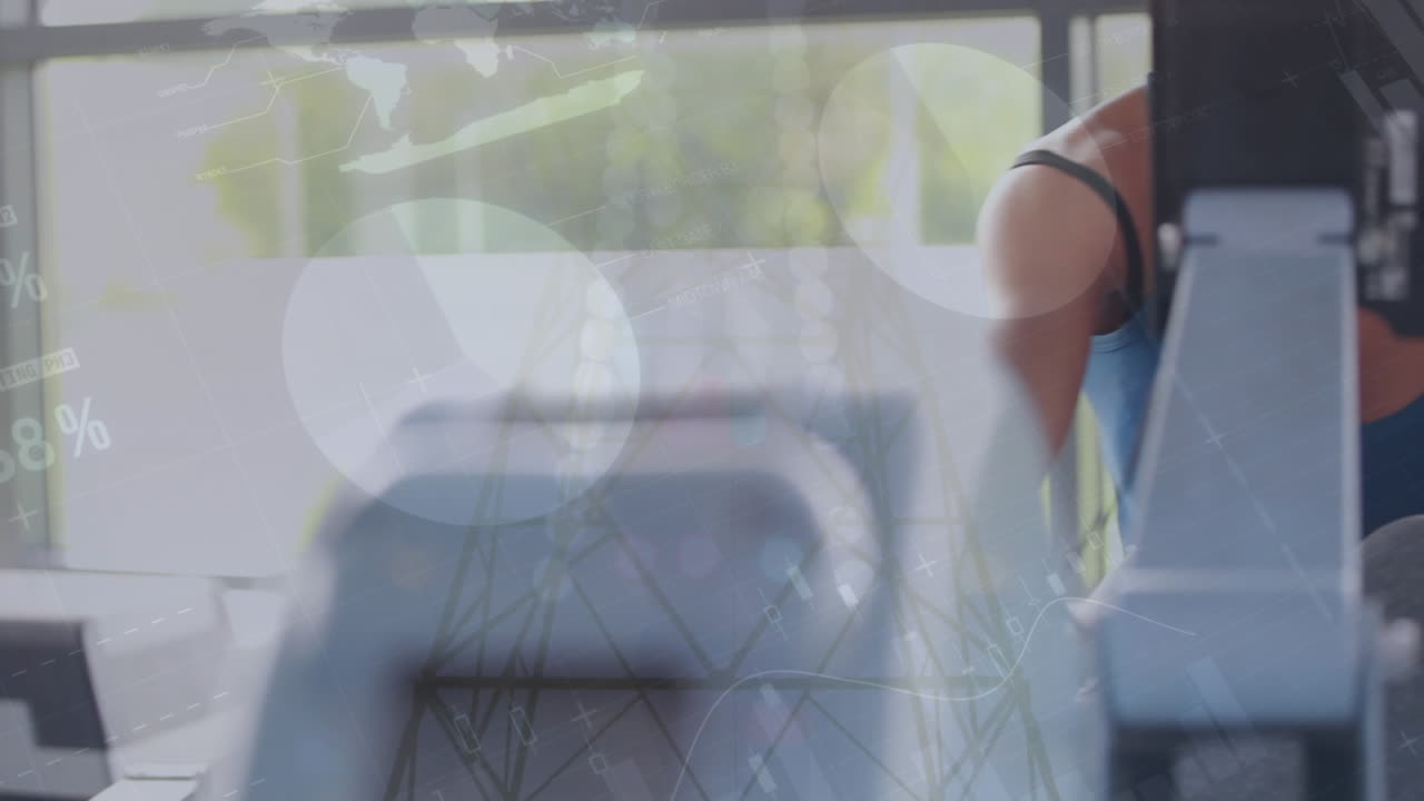 Animation of statistical data processing over caucasian fit woman using rowing machine at the gym