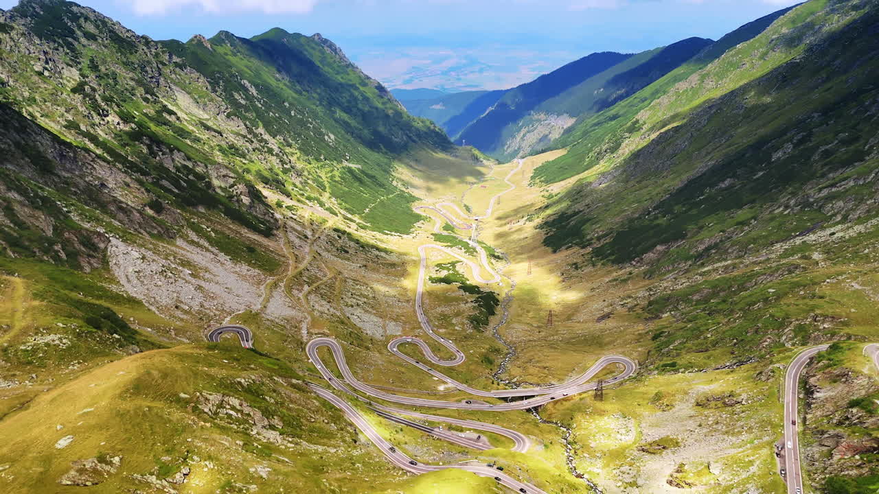 Amazing Transfagarash highway in Romania. Aerial view on the wavy road in the mountains with cars moving by