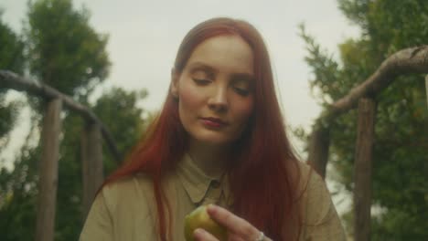 woman holding apple in a garden