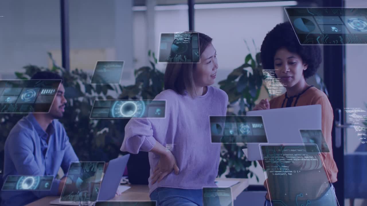 Animation of digital screens over diverse business people using laptop