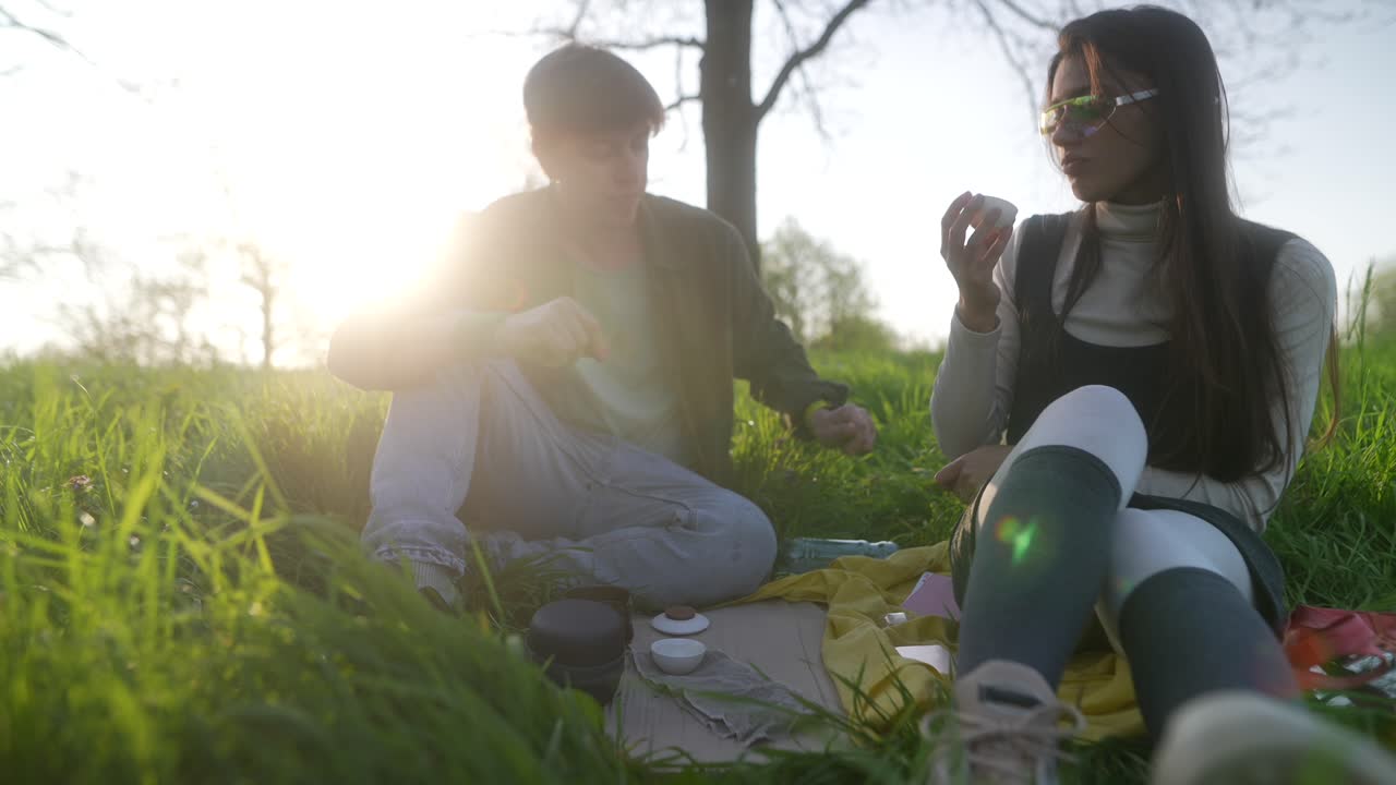Couple enjoying a picnic in the park at sunset